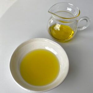 extra virgin olive oil in a bowl and in a glass jug