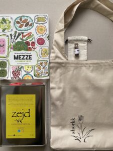 a photo of 3L tin of EVOO, the shorkk tote, Mezze cookbook and a bag of saffron