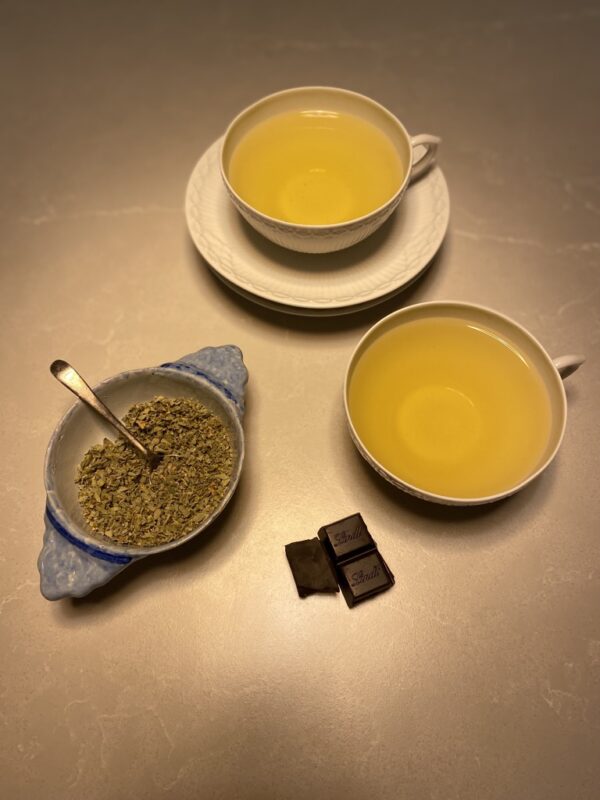 infusion of oregano as a tea, a bowl of oregano and some chocolate